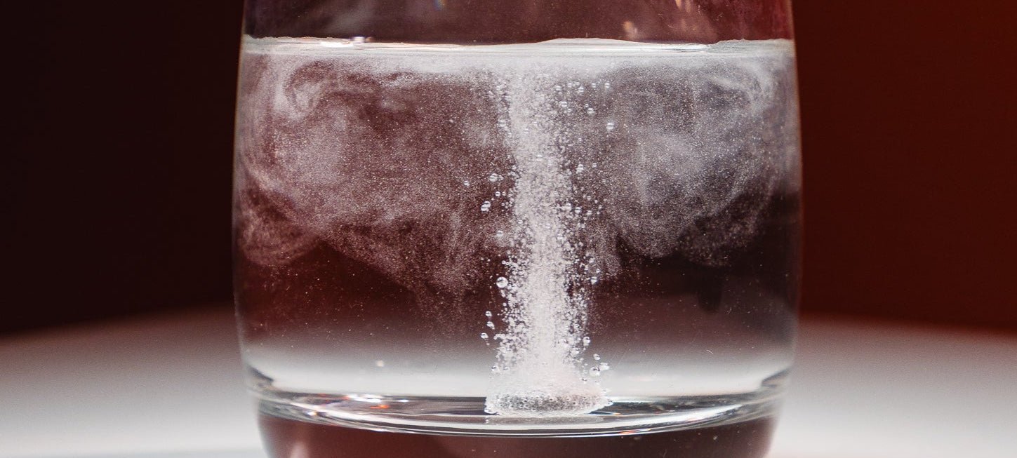 Healr H2 Hydrogen Water Tablet Dissolving in Glass and producing Hydrogen Gas